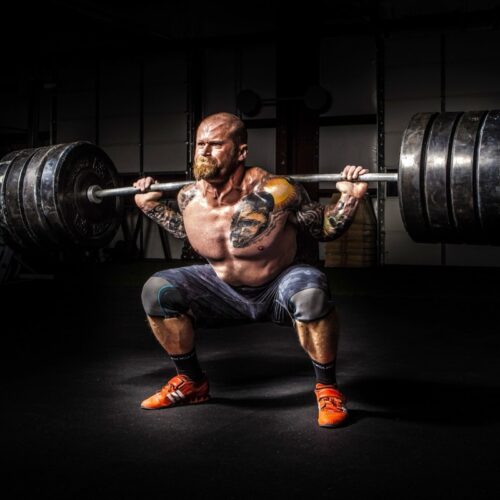 The physics of how Olympic weightlifters exploit barbell's "whip"